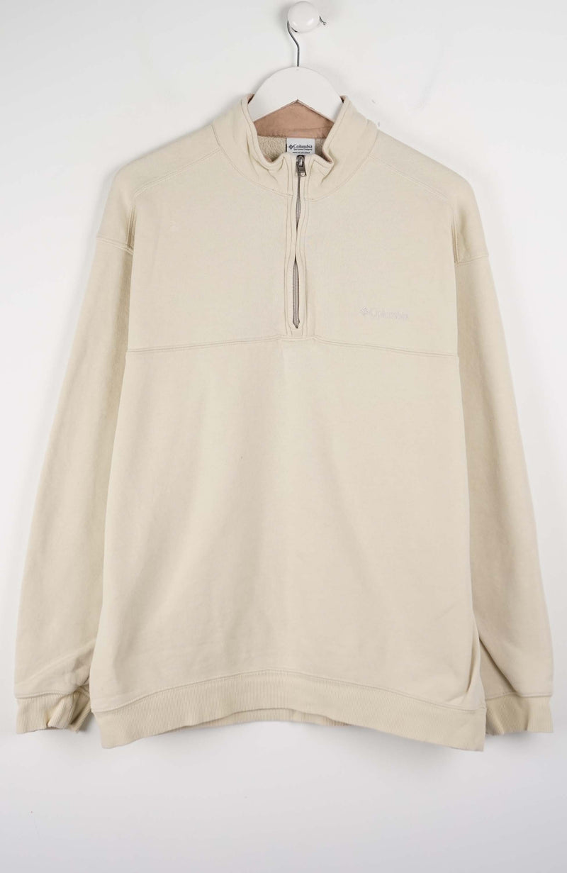 Beige fleece pullover on a hanger against a white background