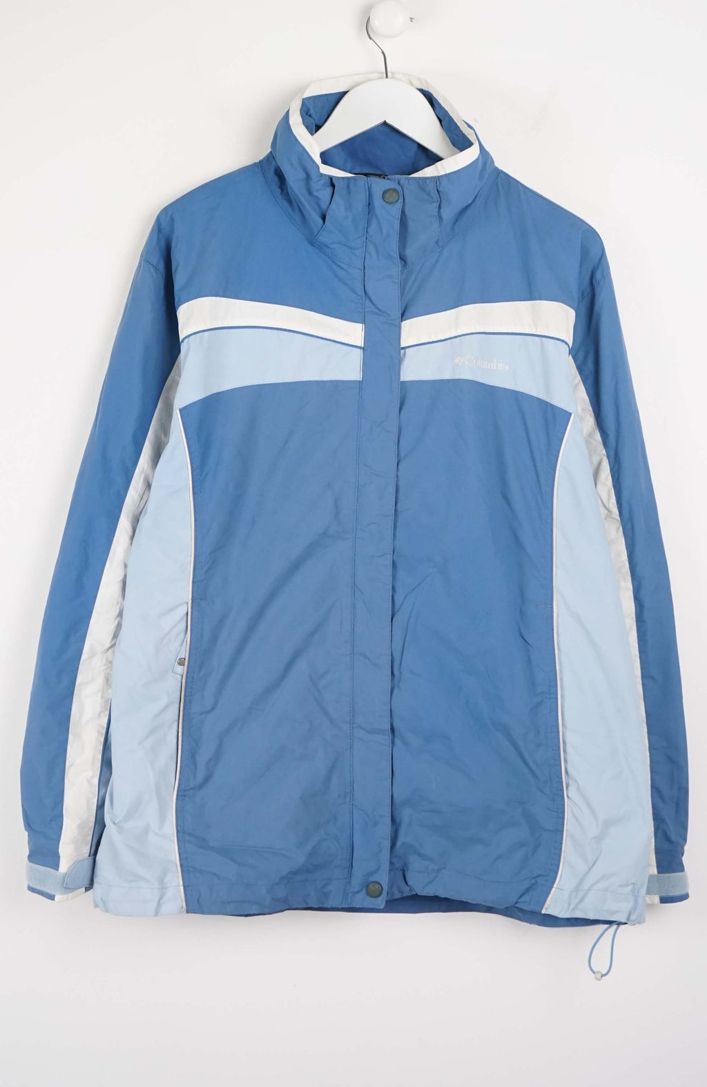 Blue jacket with white accents on a hanger against a white background