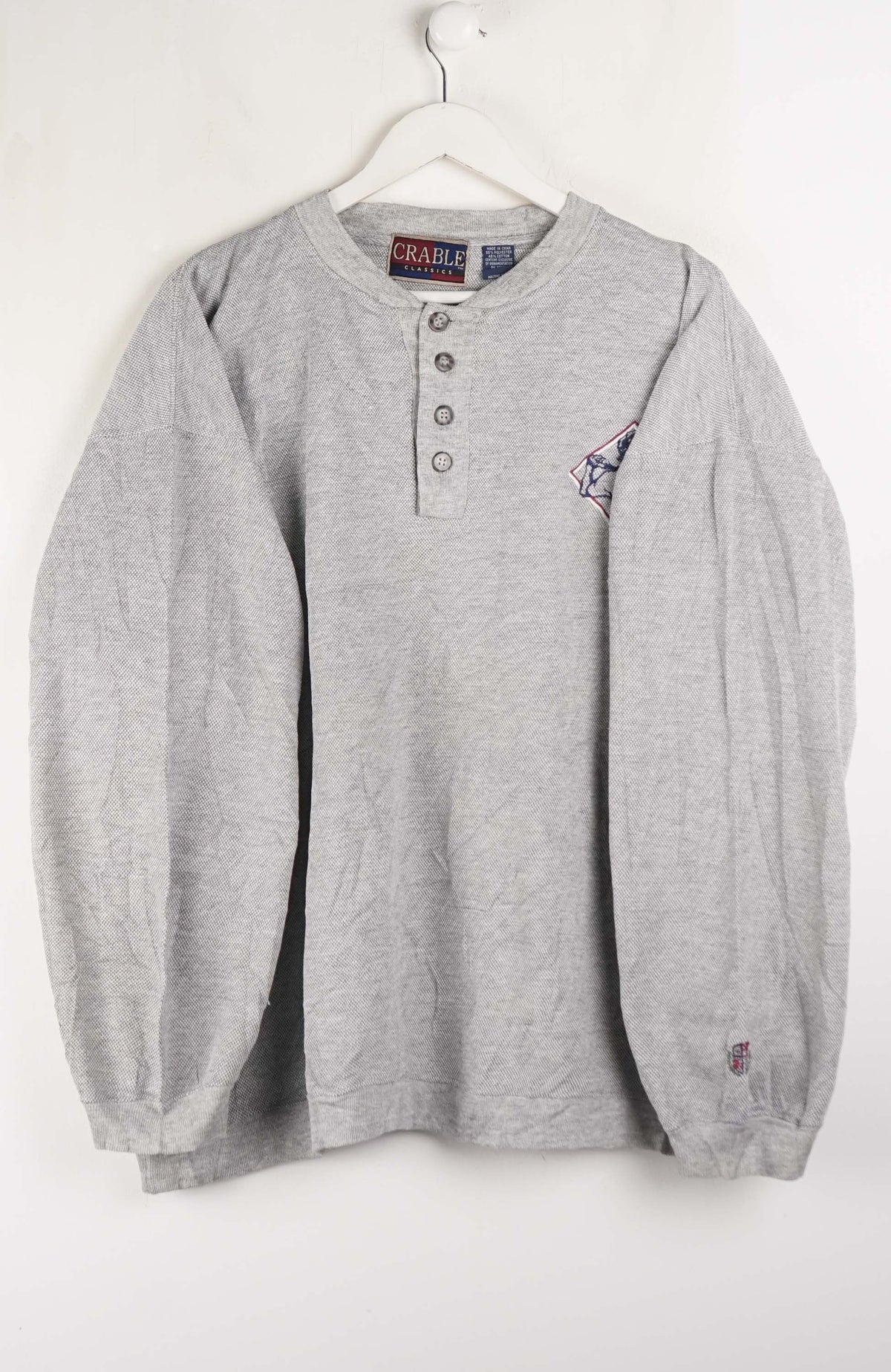 Gray long-sleeve shirt with brand logo on a white background