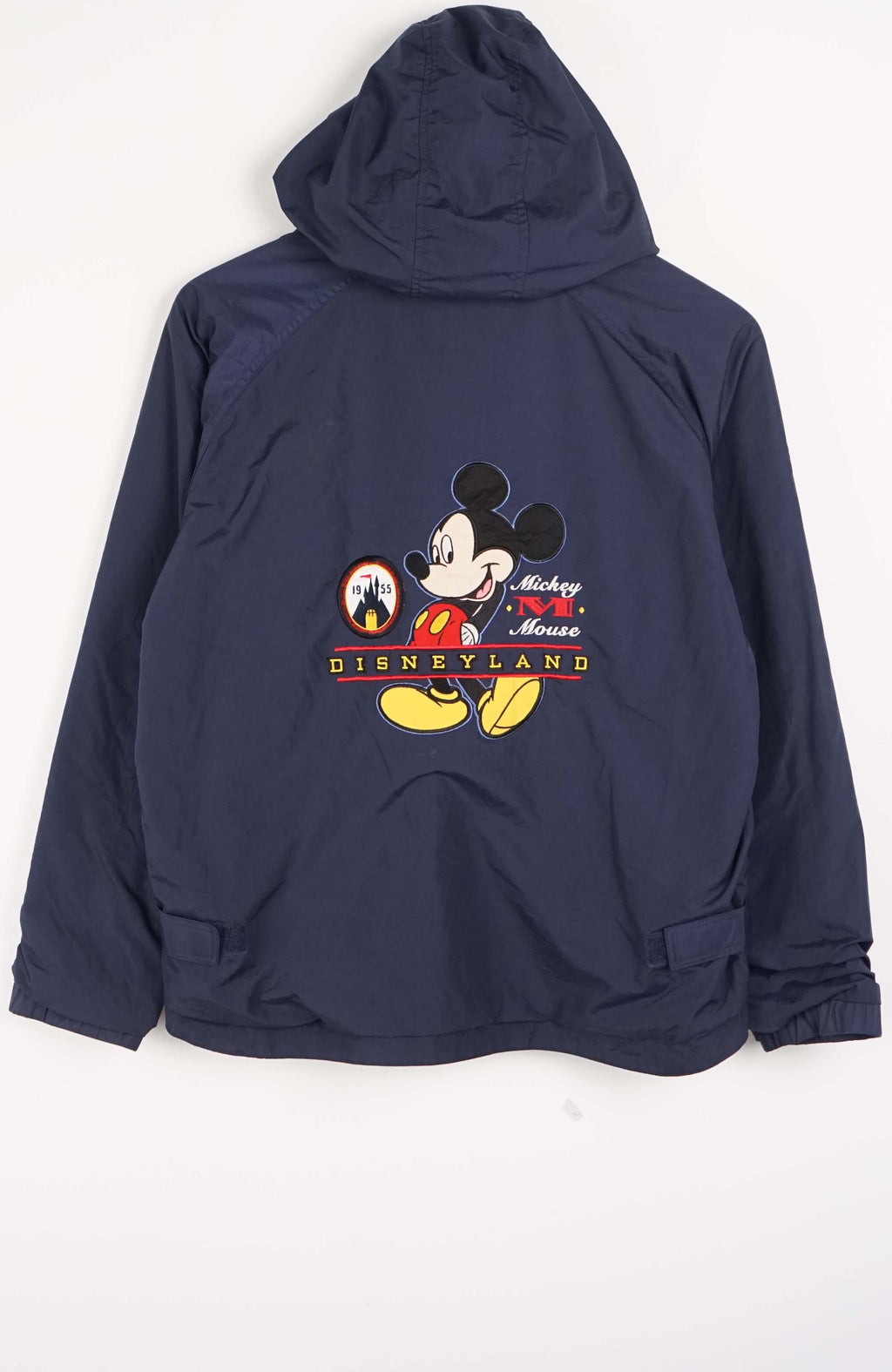 Navy blue jacket with a logo on the chest against a white background