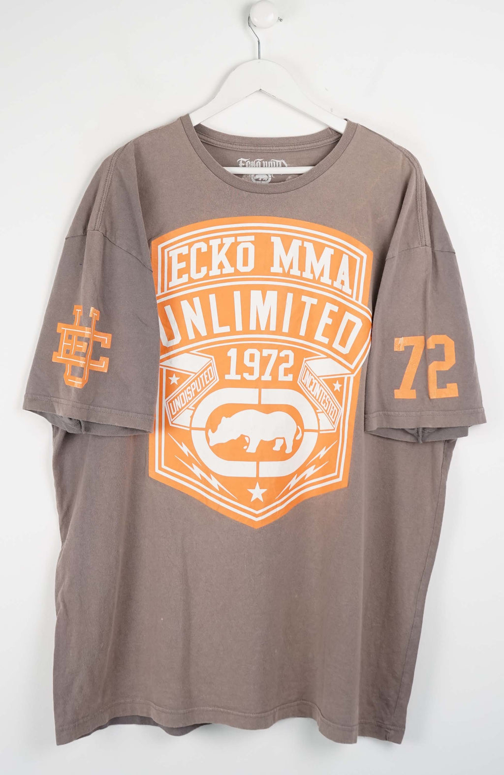 Gray t-shirt with orange and white graphics on a white background