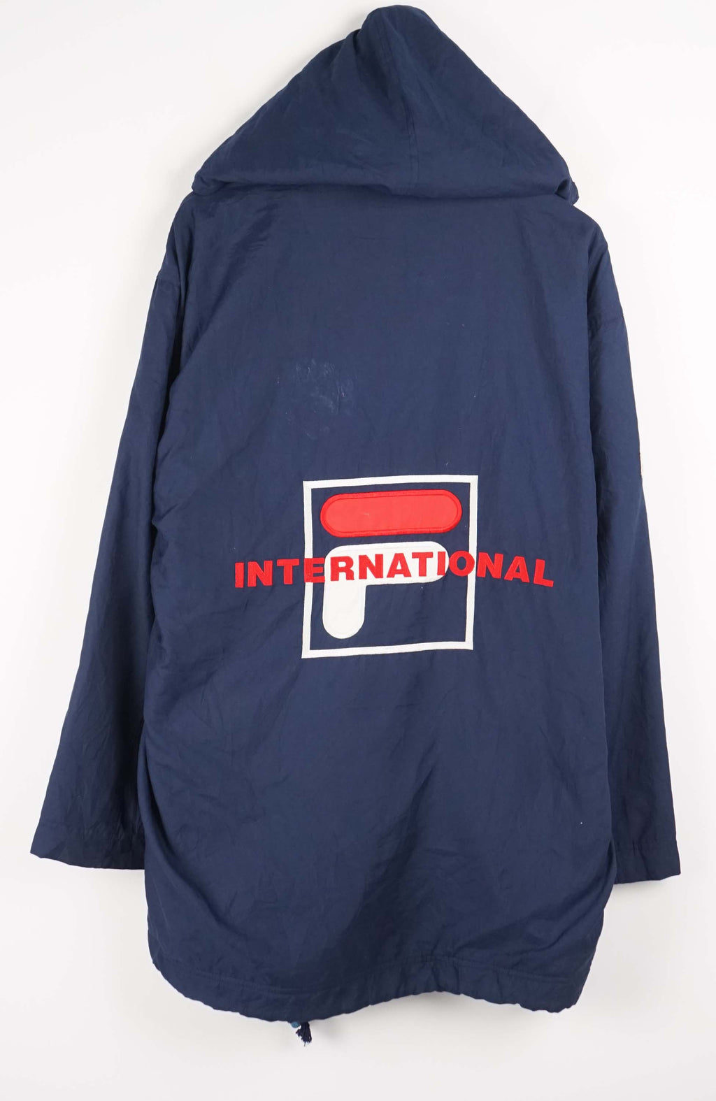 Navy blue jacket with red accents and FILA logo on a white background