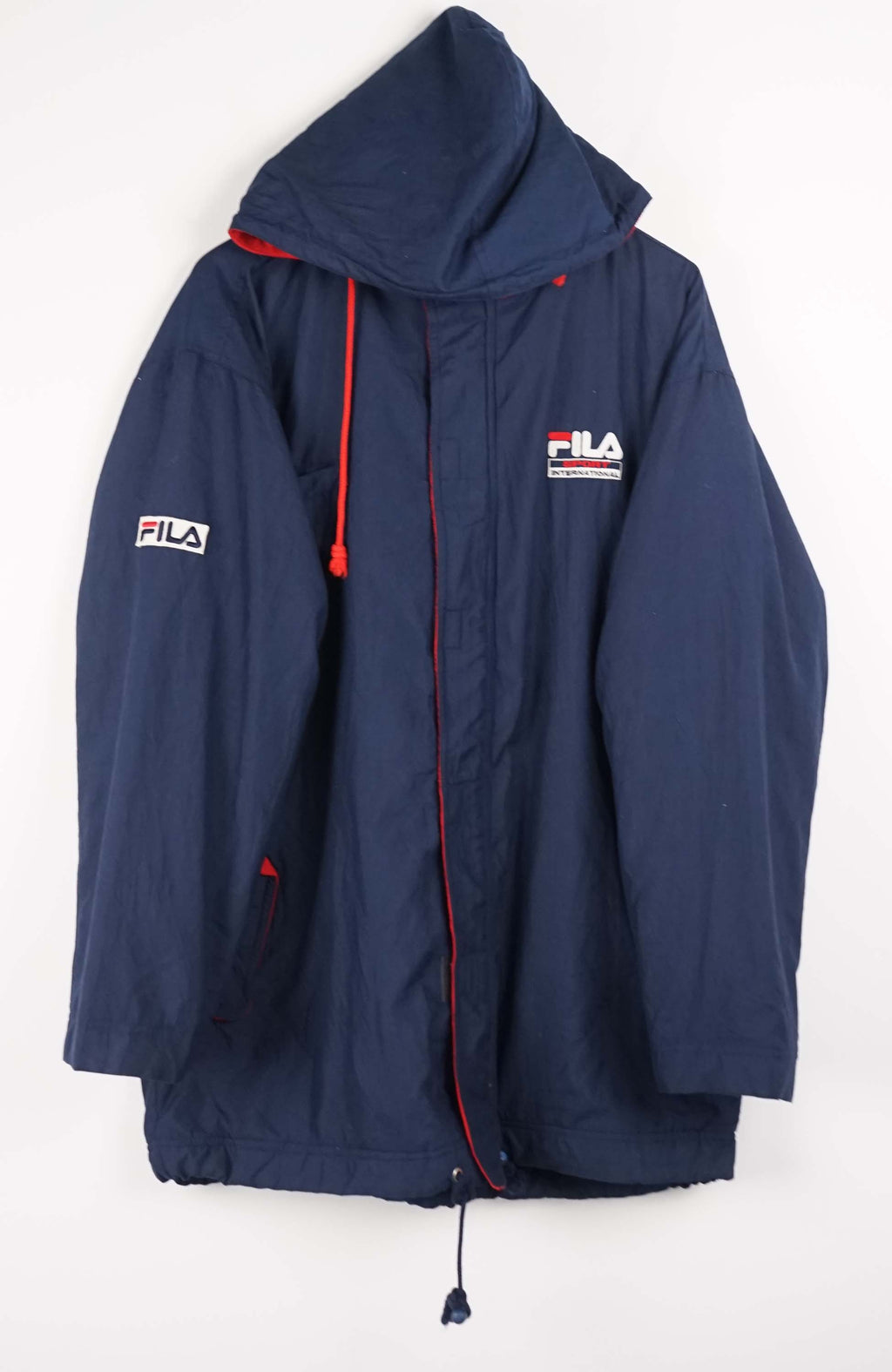 Navy blue jacket with red accents and FILA logo on a white background