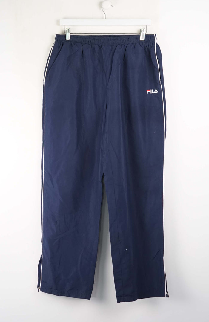 Navy blue pants with a white brand logo on a white background