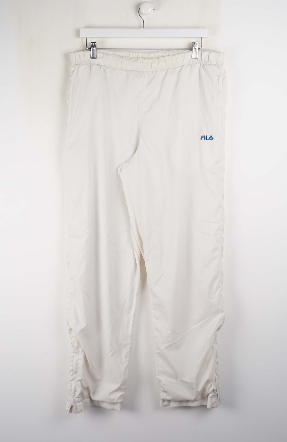White pants with a visible brand logo on a white background