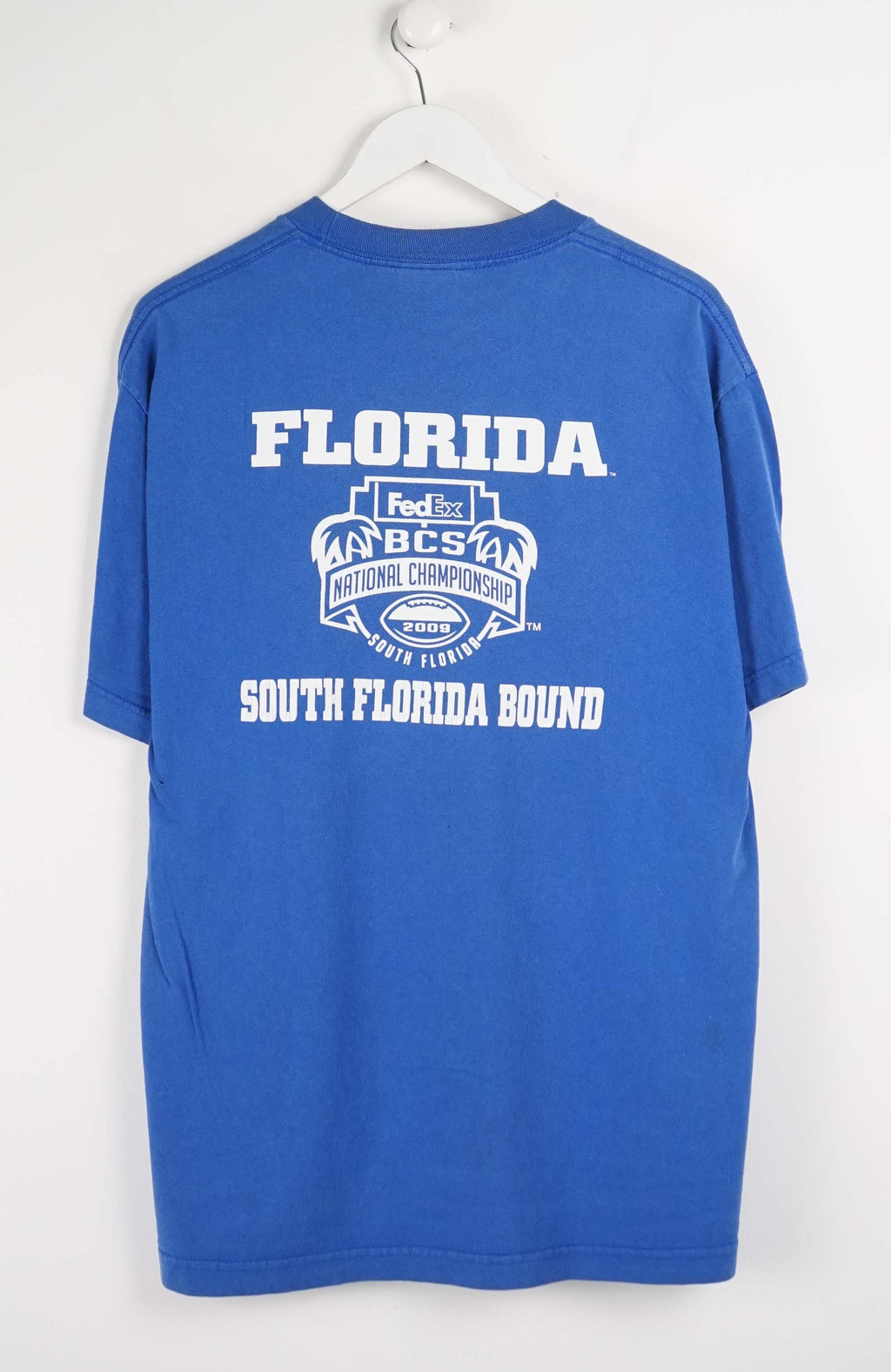 Blue t-shirt with Florida Gators logo and text on a white background