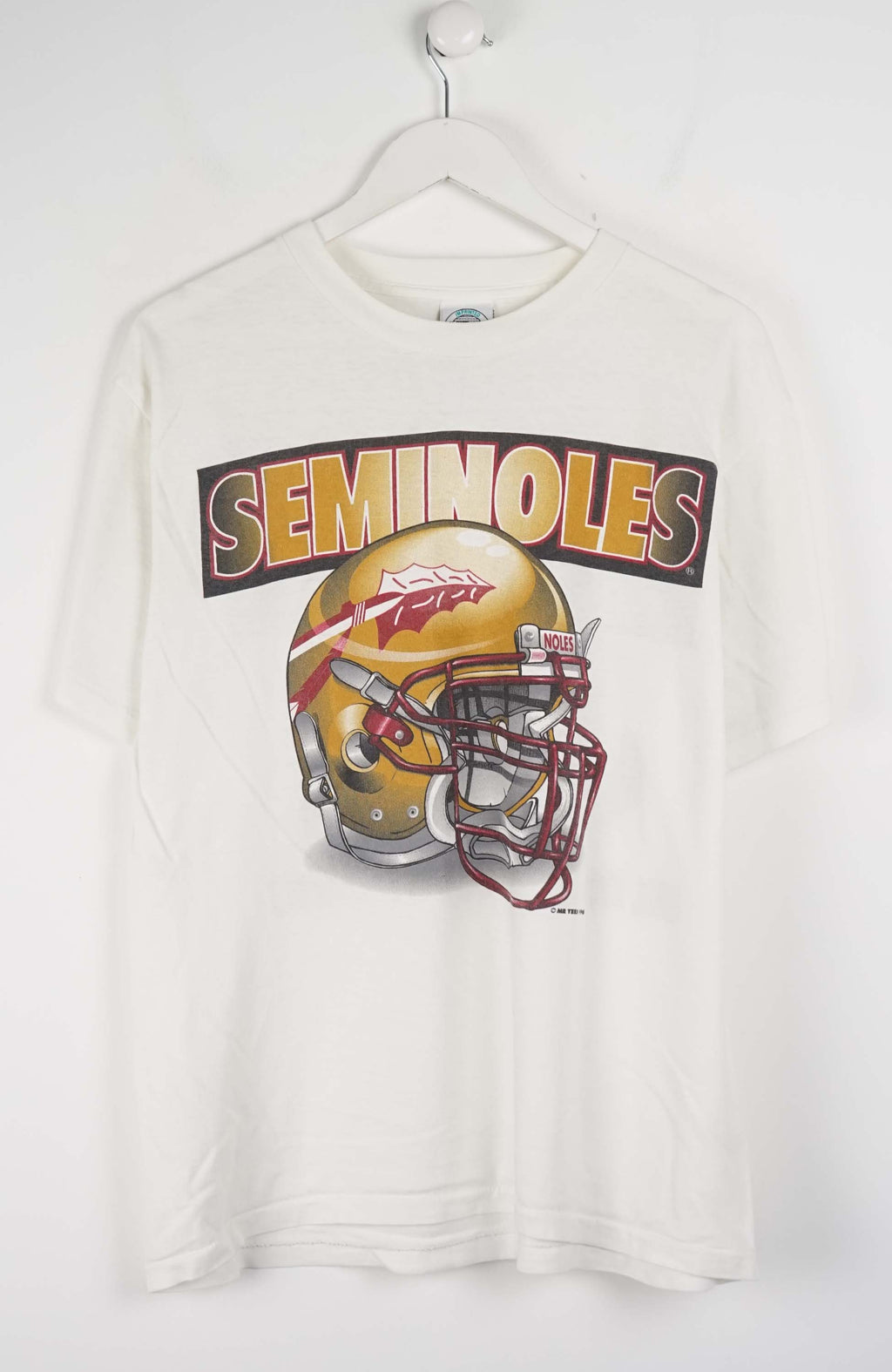 White t-shirt with a football helmet and 'Seminoles' text on a hanger against a white background