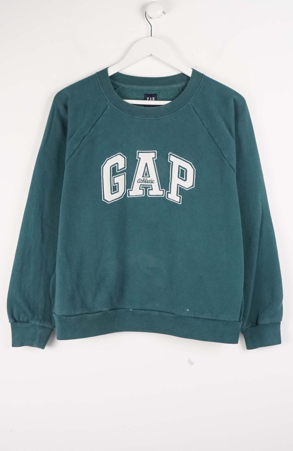 Green Gap sweatshirt on a white hanger