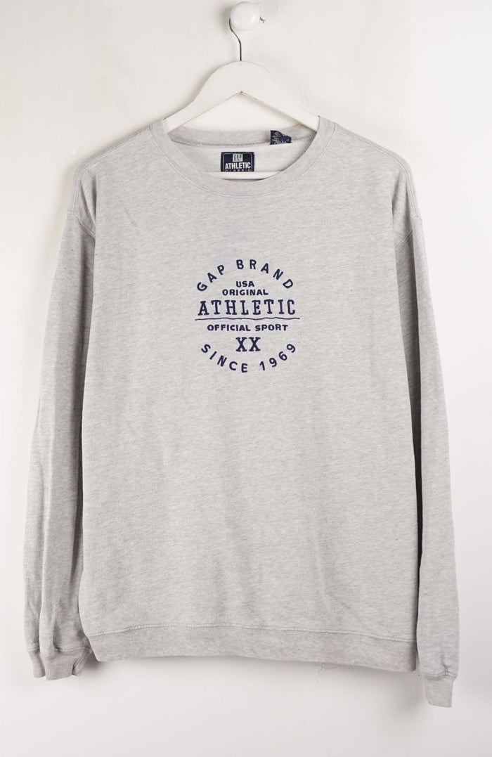 Gray sweatshirt with 'Gap Brand Athletic' text on a white background