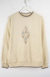 Beige sweatshirt with a decorative pattern on a white background