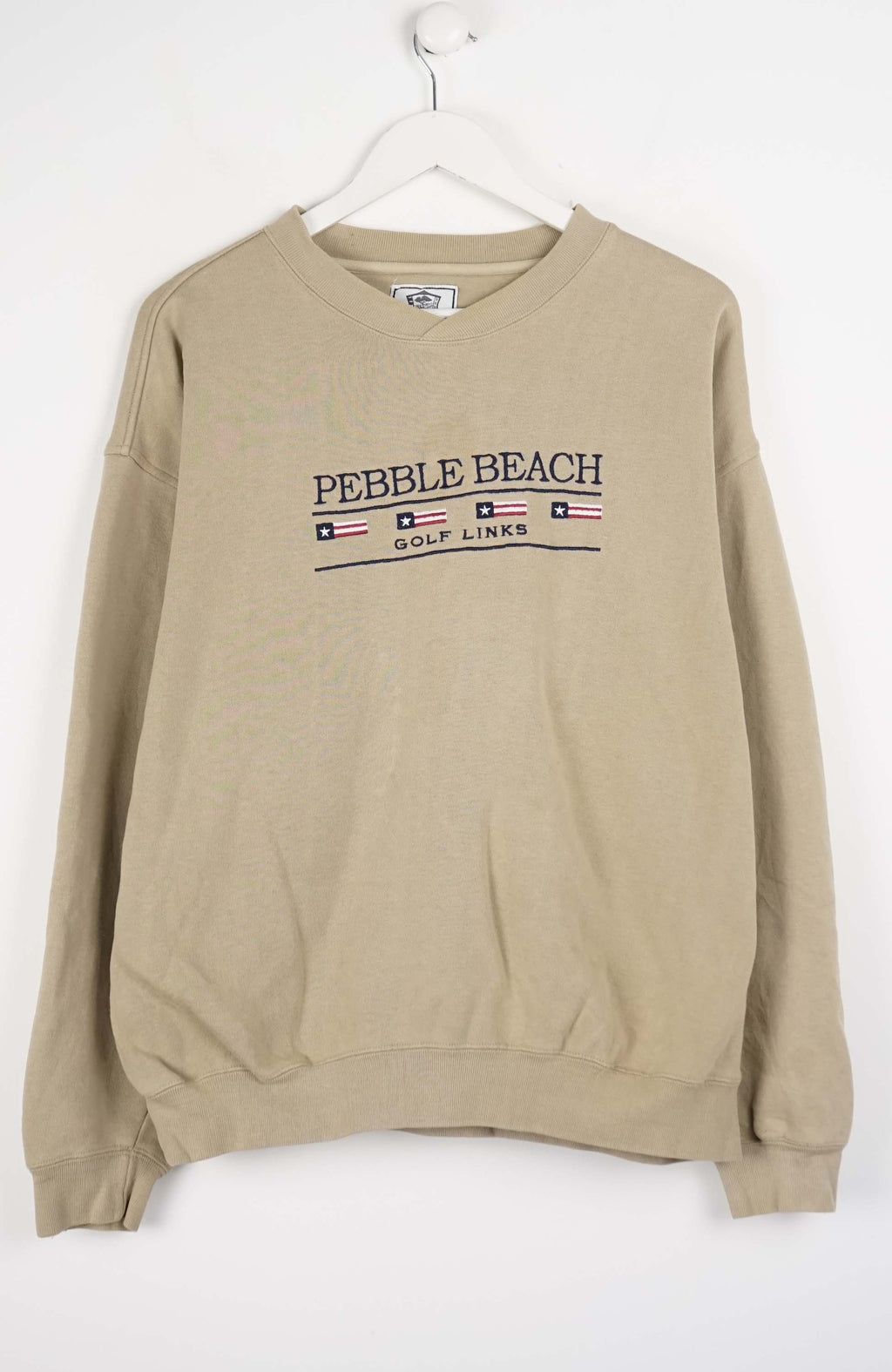 Beige sweatshirt with 'Pebble Beach Golf Links' text on a white background