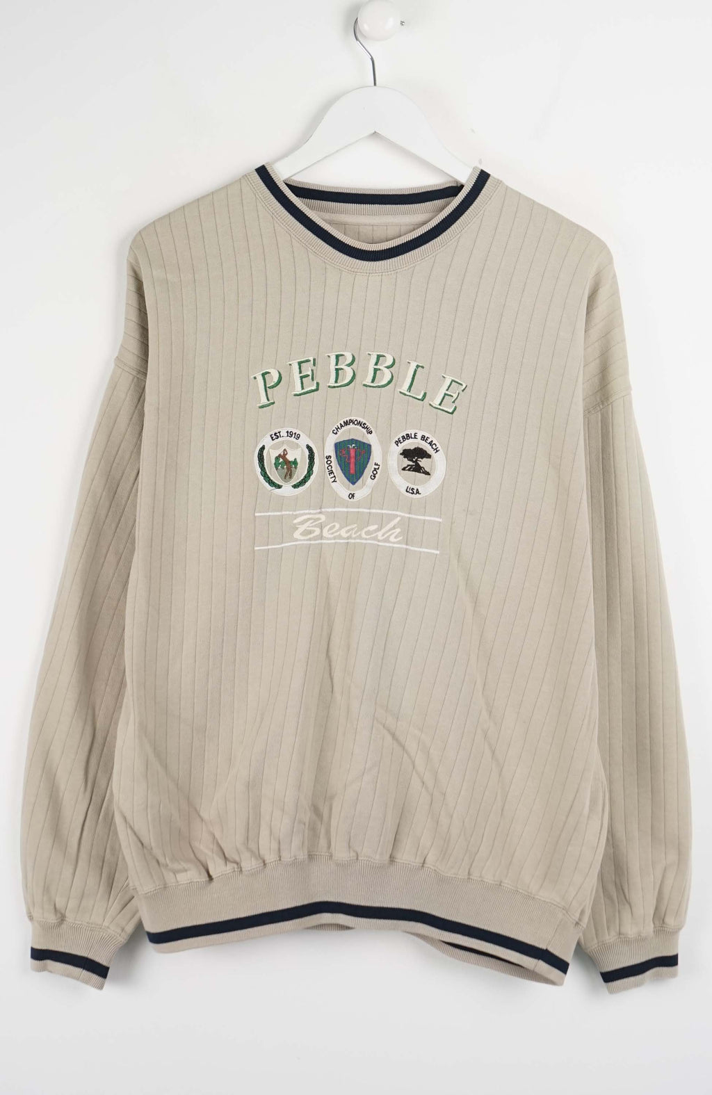 Beige ribbed sweater with 'Pebble' branding on a white background