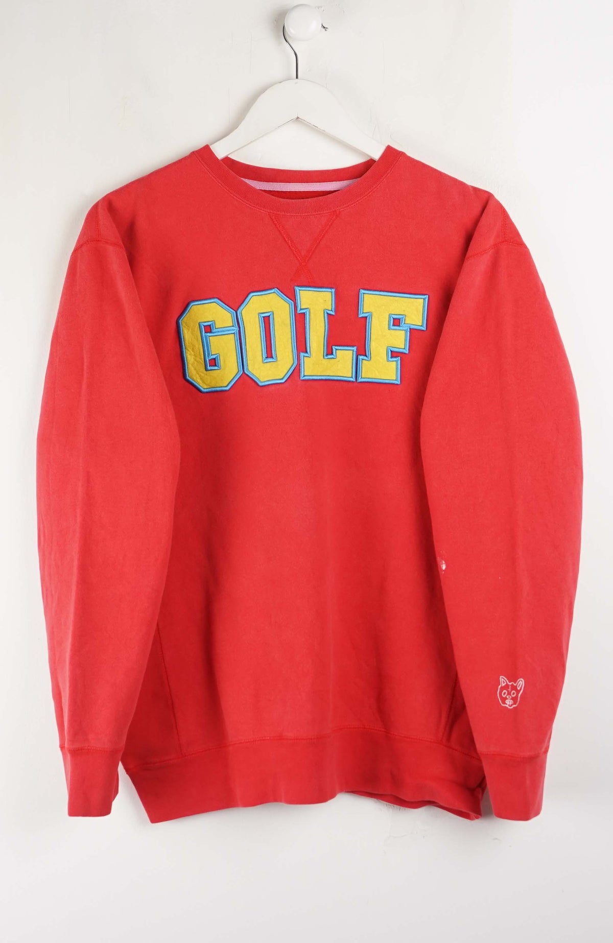 Red sweatshirt with 'GOLF' printed in yellow and blue on a white background