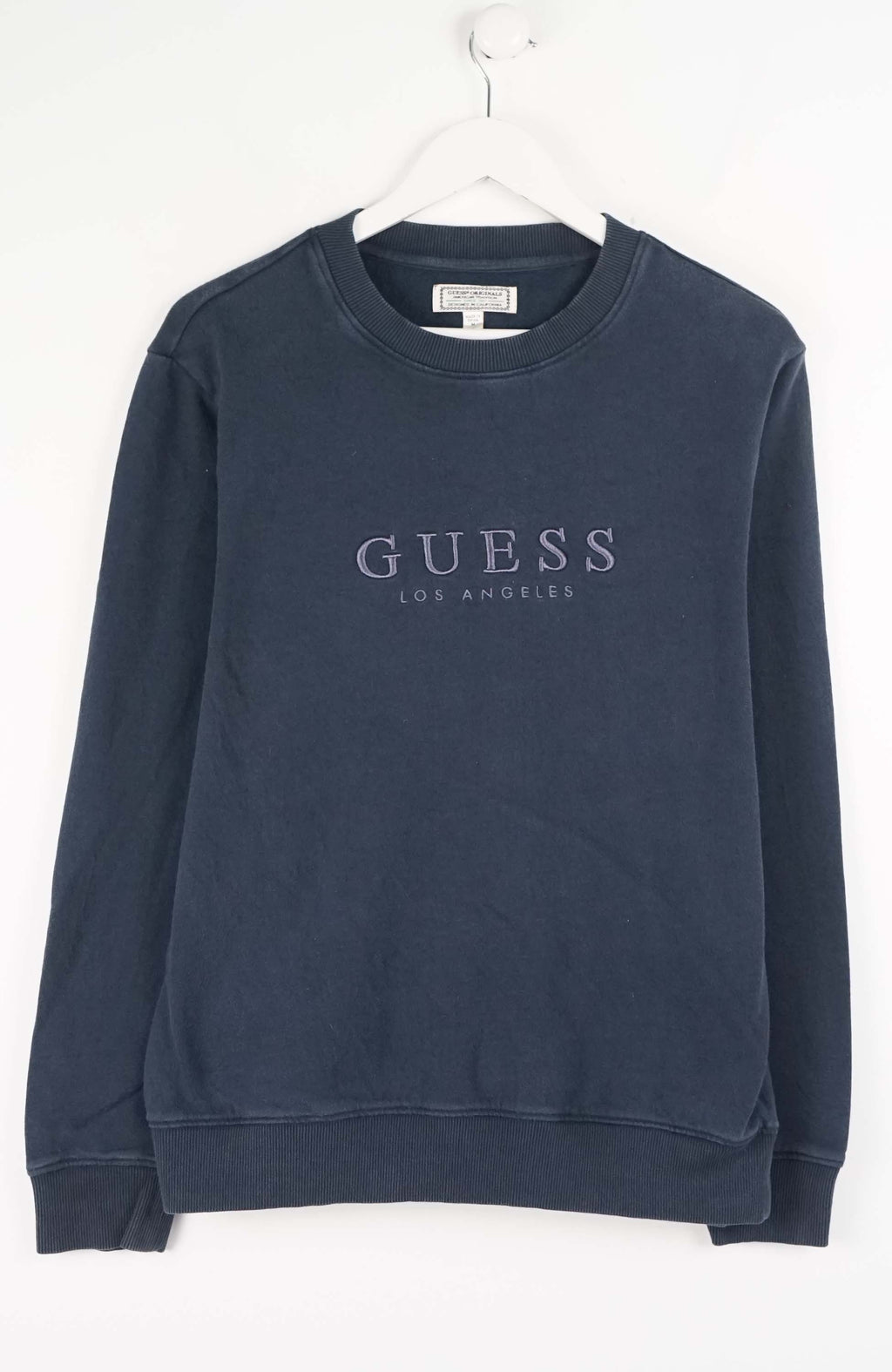 Navy blue sweatshirt with 'Guess' logo on a white background