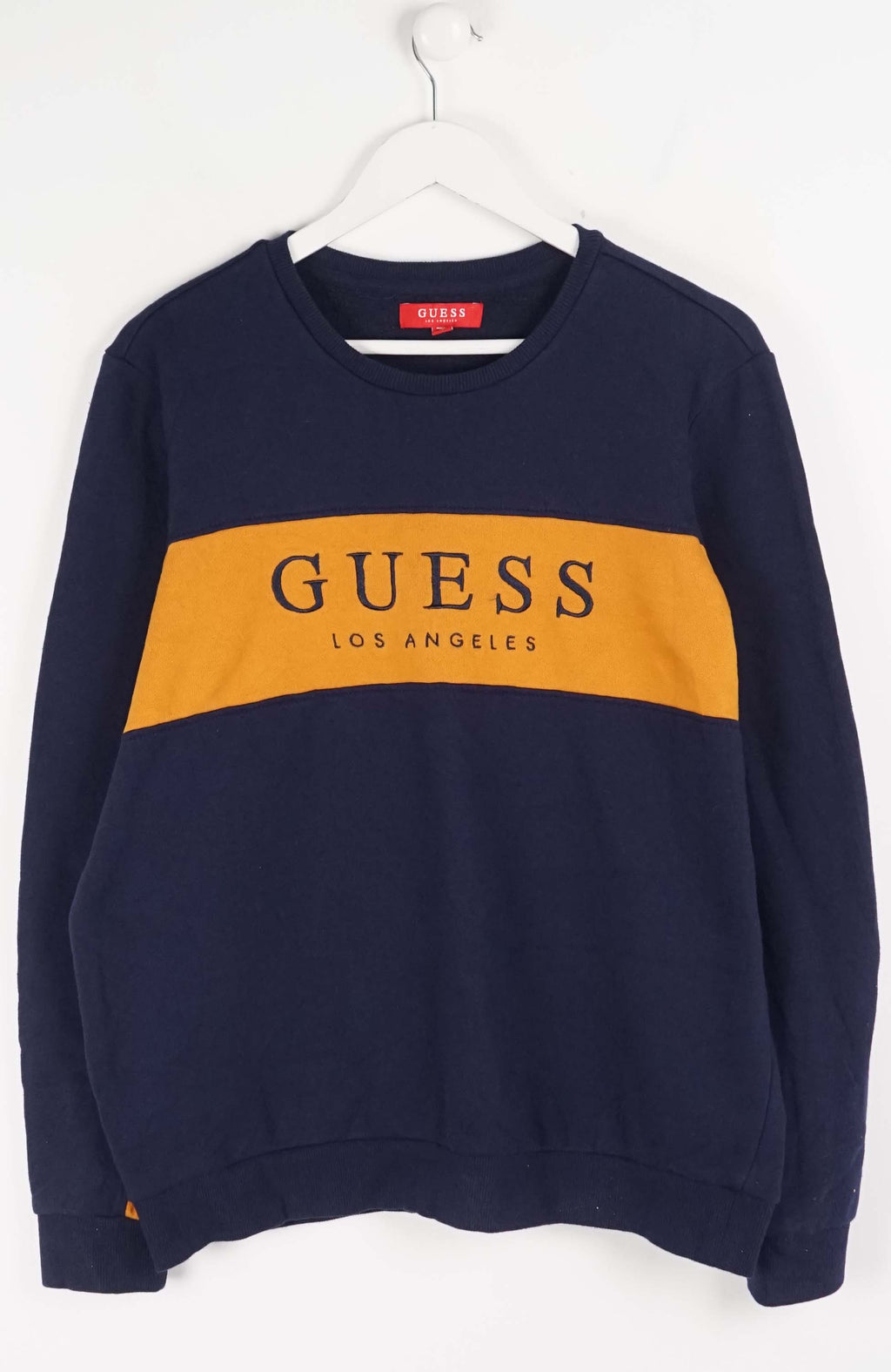 Navy blue sweatshirt with yellow Guess logo on a white background