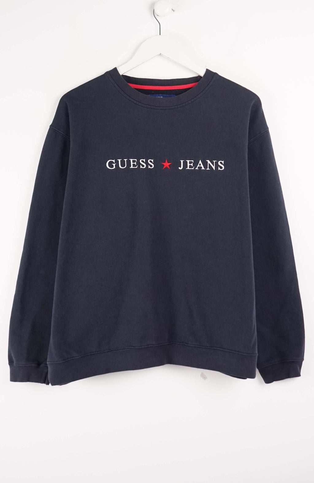 Navy blue sweatshirt with Guess Jeans logo on a white background