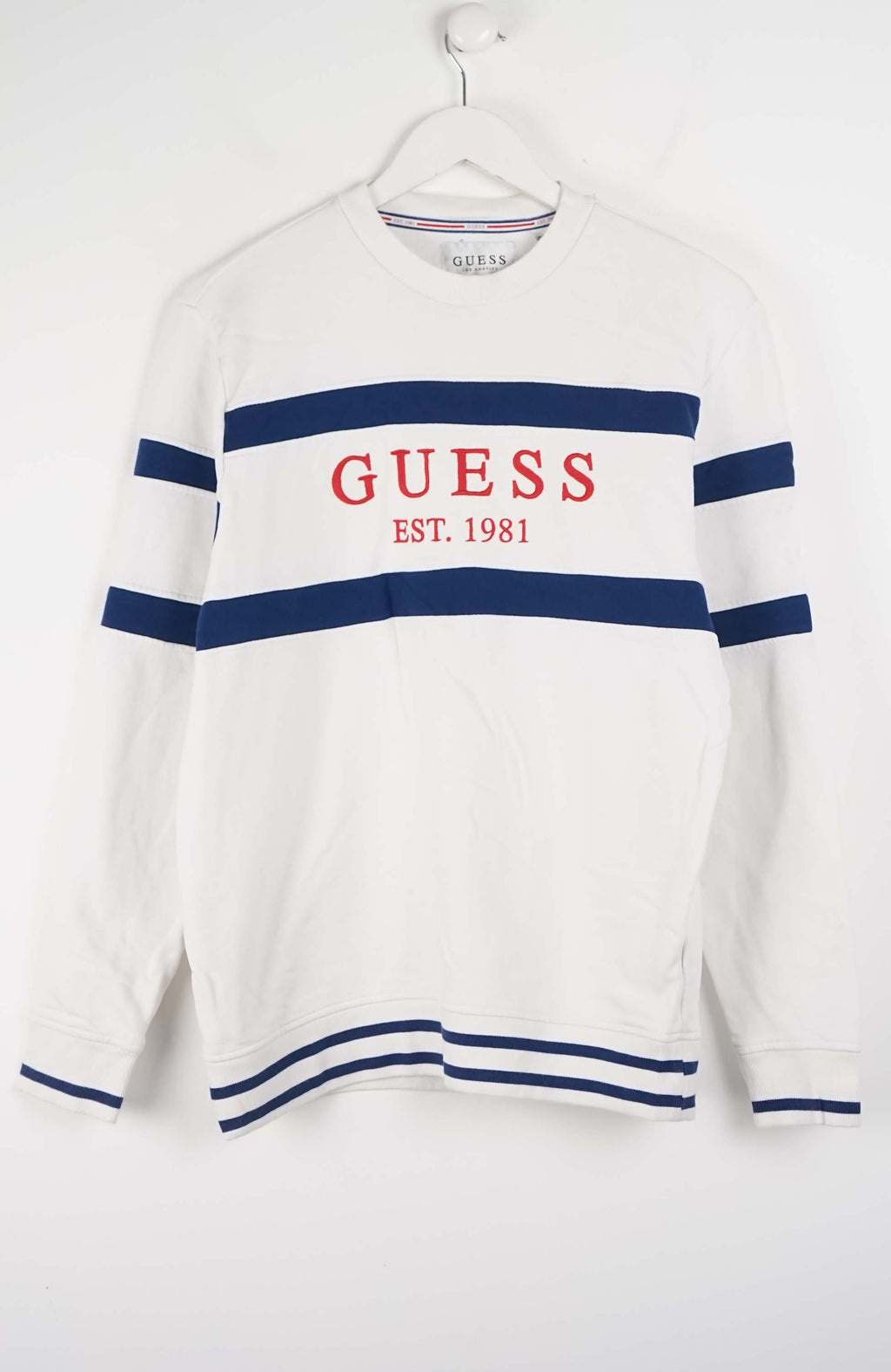 White sweater with blue stripes and red 'Guess' logo on a white background