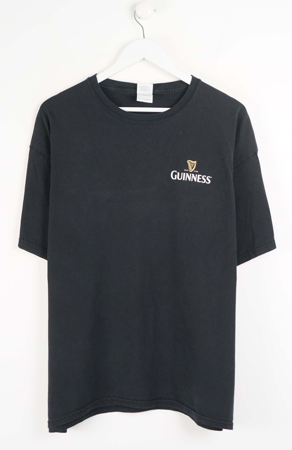 Black t-shirt with Guinness logo on a white background