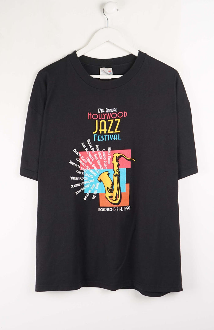 Black t-shirt with colorful 'Hollywood Jazz Festival' graphic on a white background