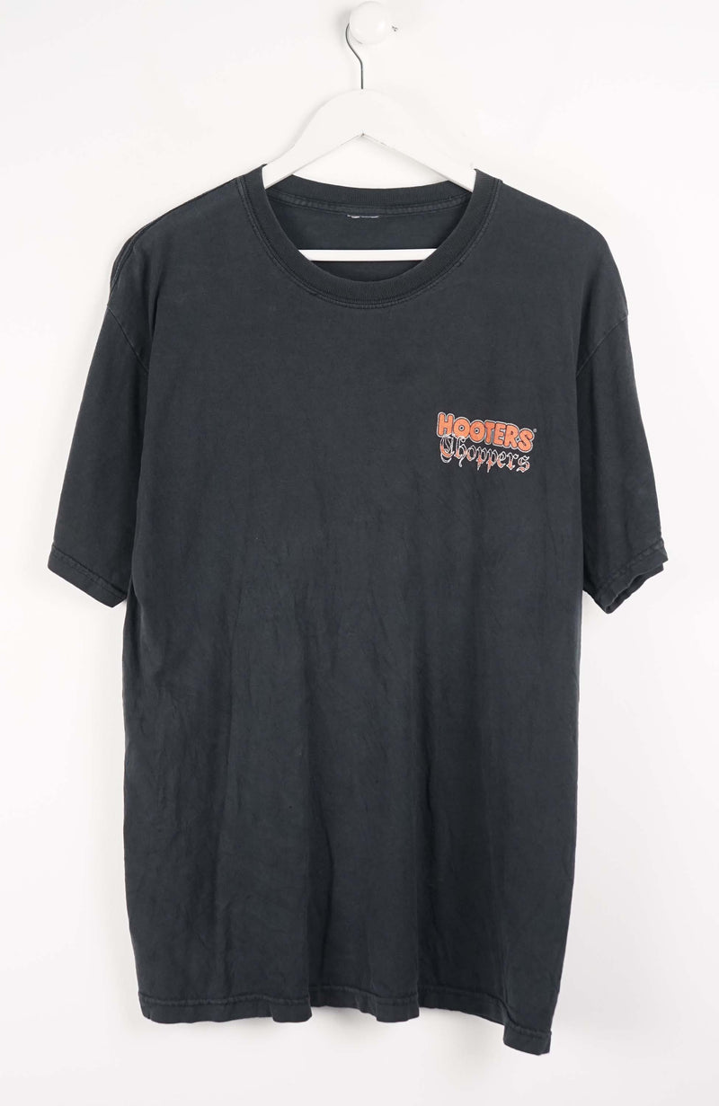 Black t-shirt with text on a white background
