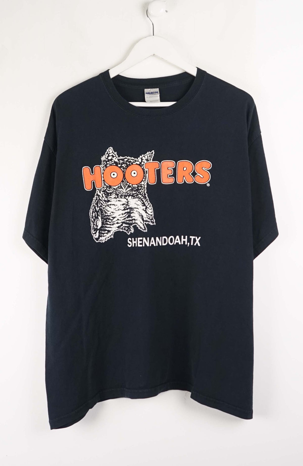 Black t-shirt with Hooters logo and text on a white background