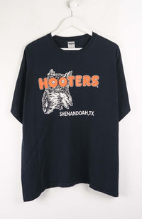 Black t-shirt with Hooters logo and text on a white background