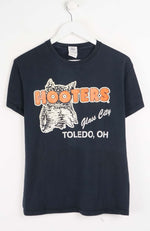 Black t-shirt with Hooters logo and text on a white background