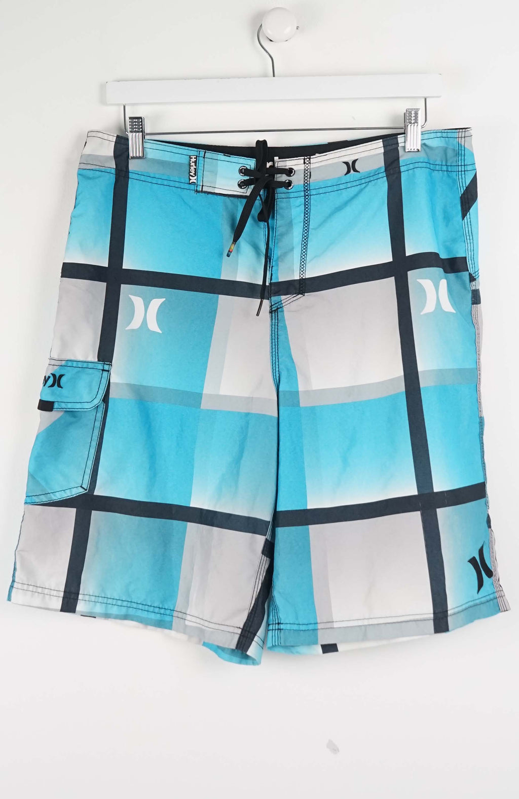 Blue and white checkered shorts with a brand logo on a white background