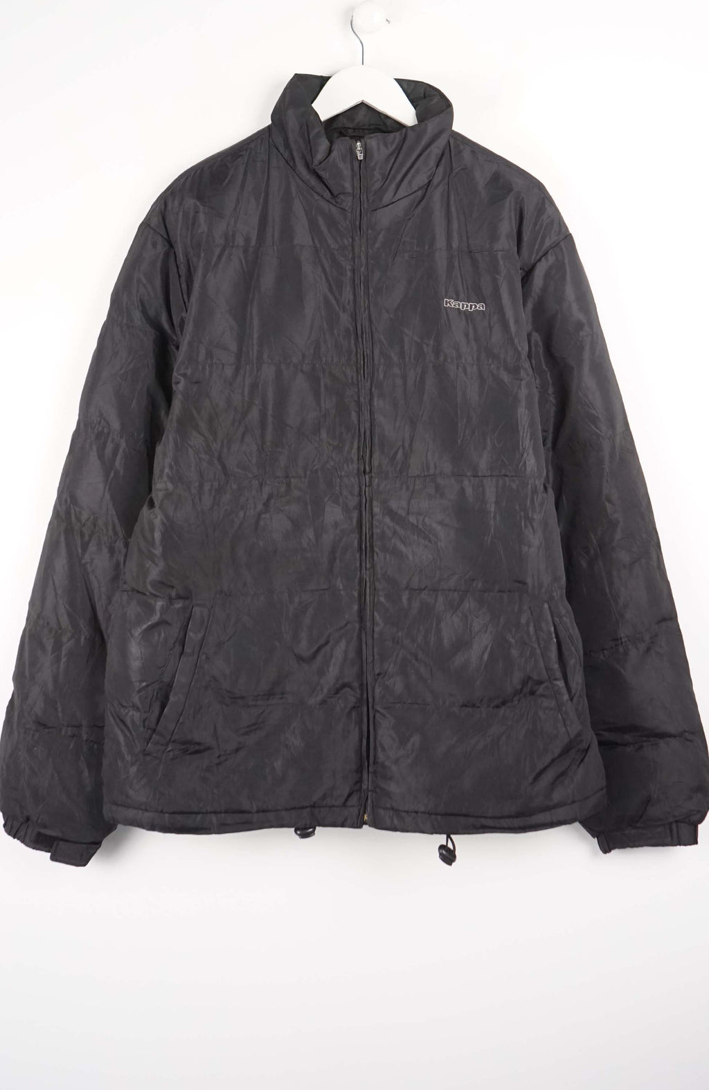 Black jacket on a hanger against a white background