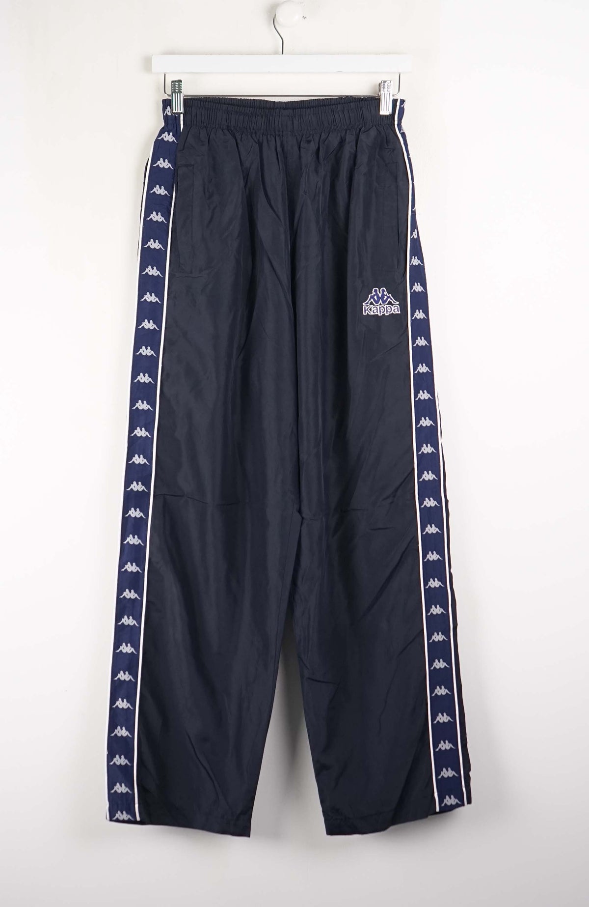 Navy track pants with white stripes and brand logo on a white background