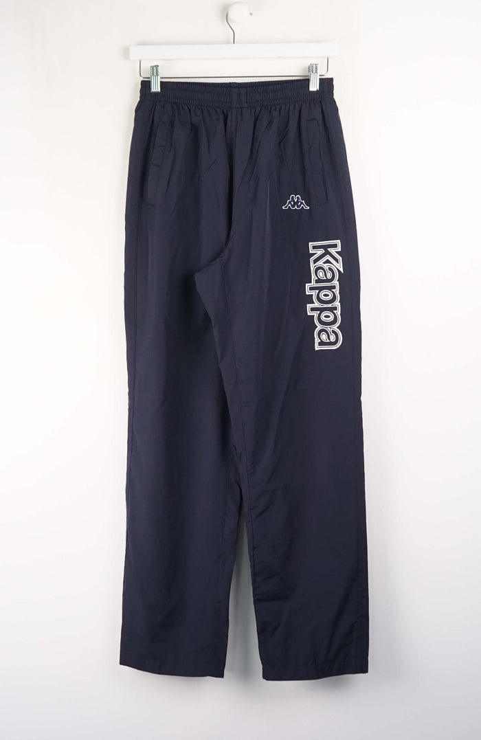 Navy blue pants with 'Kappa' logo on a white background