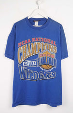 Blue t-shirt with 'NCAA National Champions Kentucky Wildcats' text on a white background