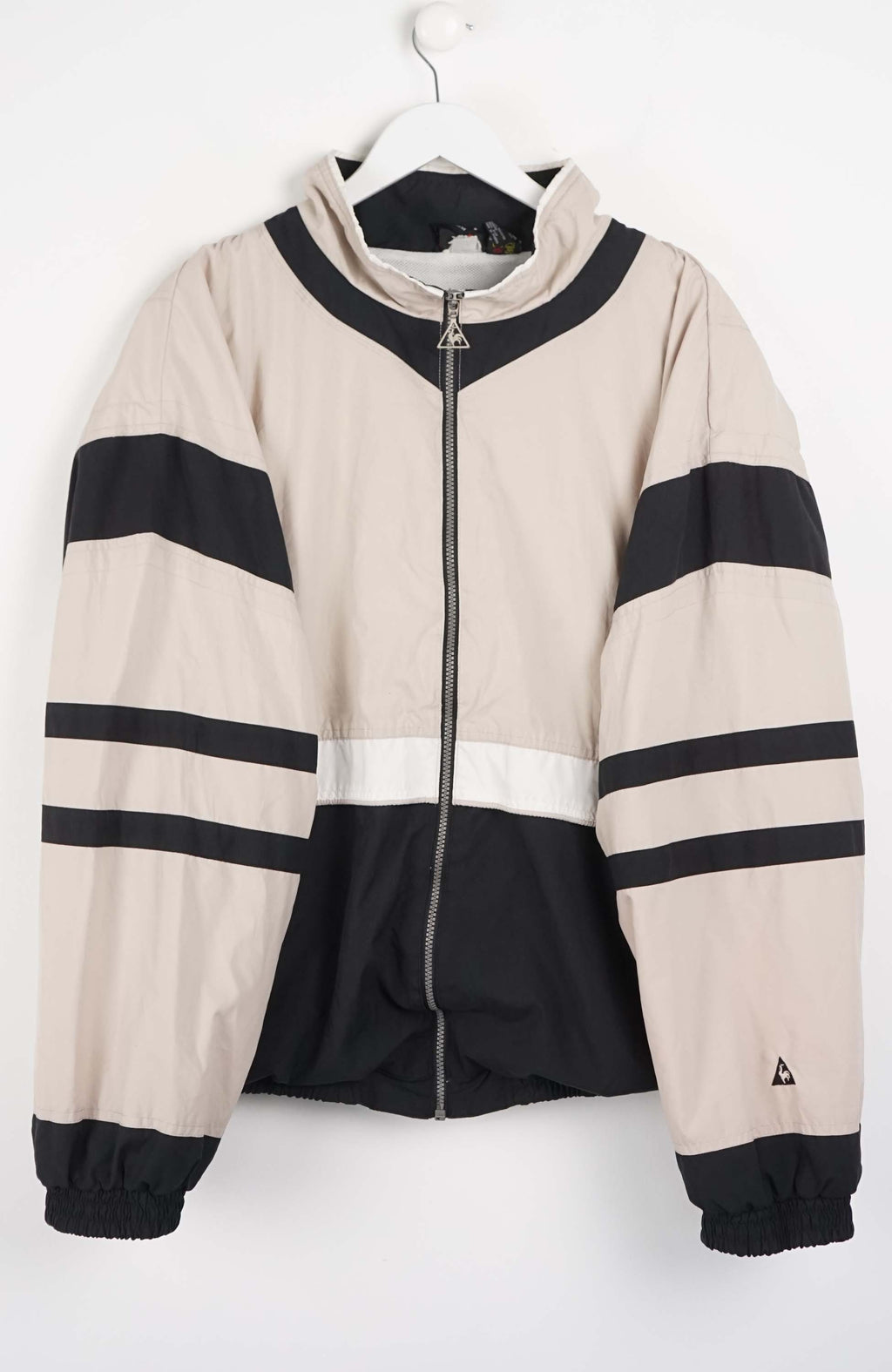 Beige and black jacket with striped pattern on a white background