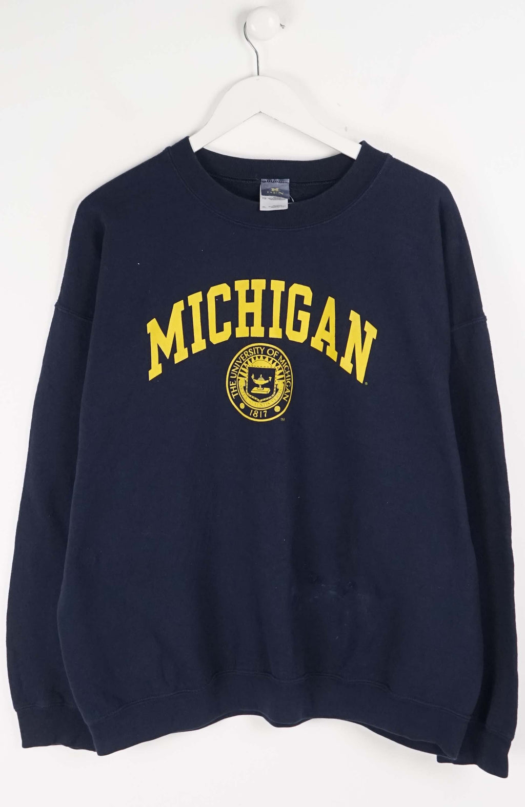 Navy blue sweatshirt with 'Michigan' printed in yellow on a white background