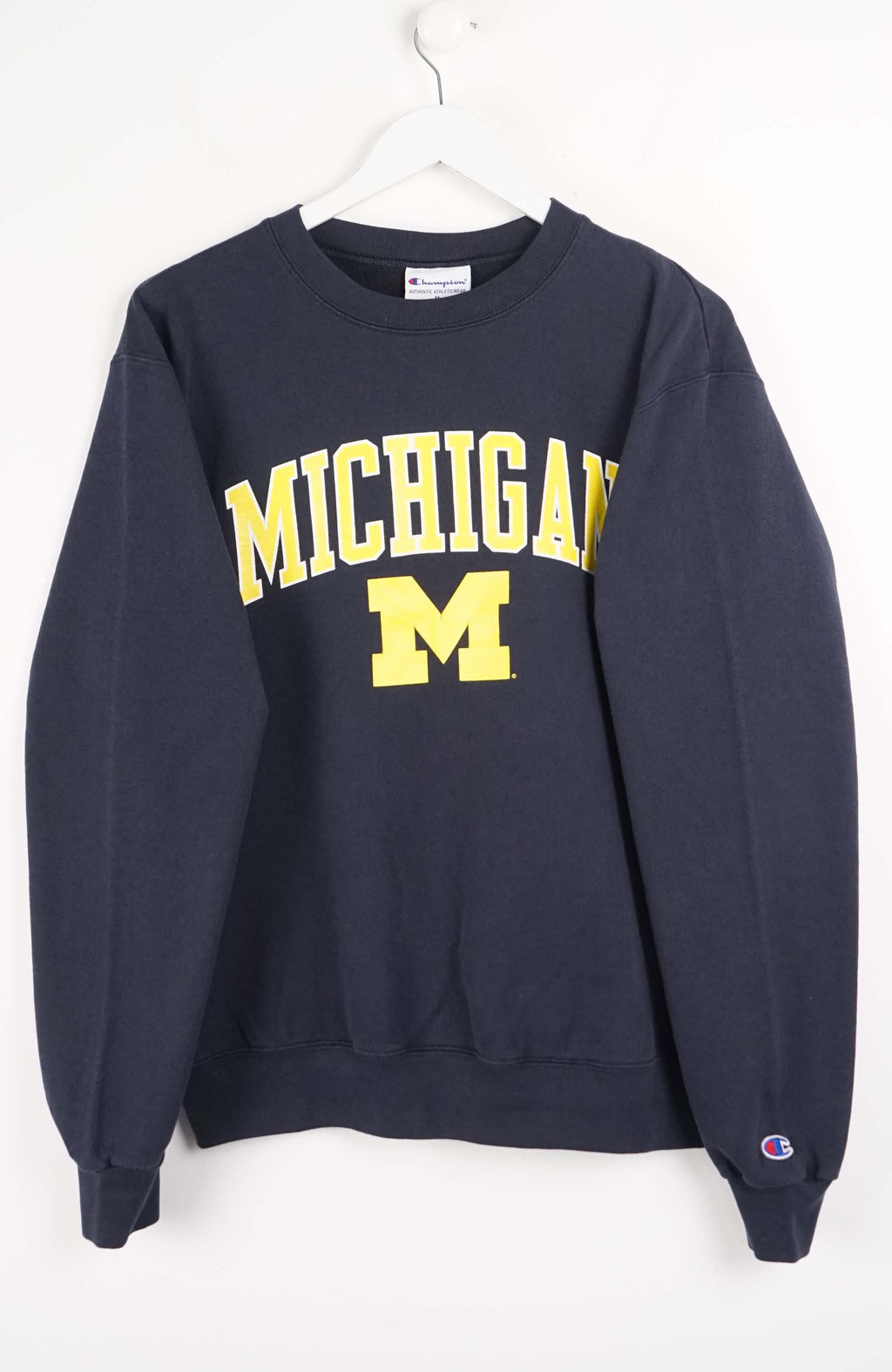 Navy sweatshirt with 'Michigan' printed in yellow on a white background