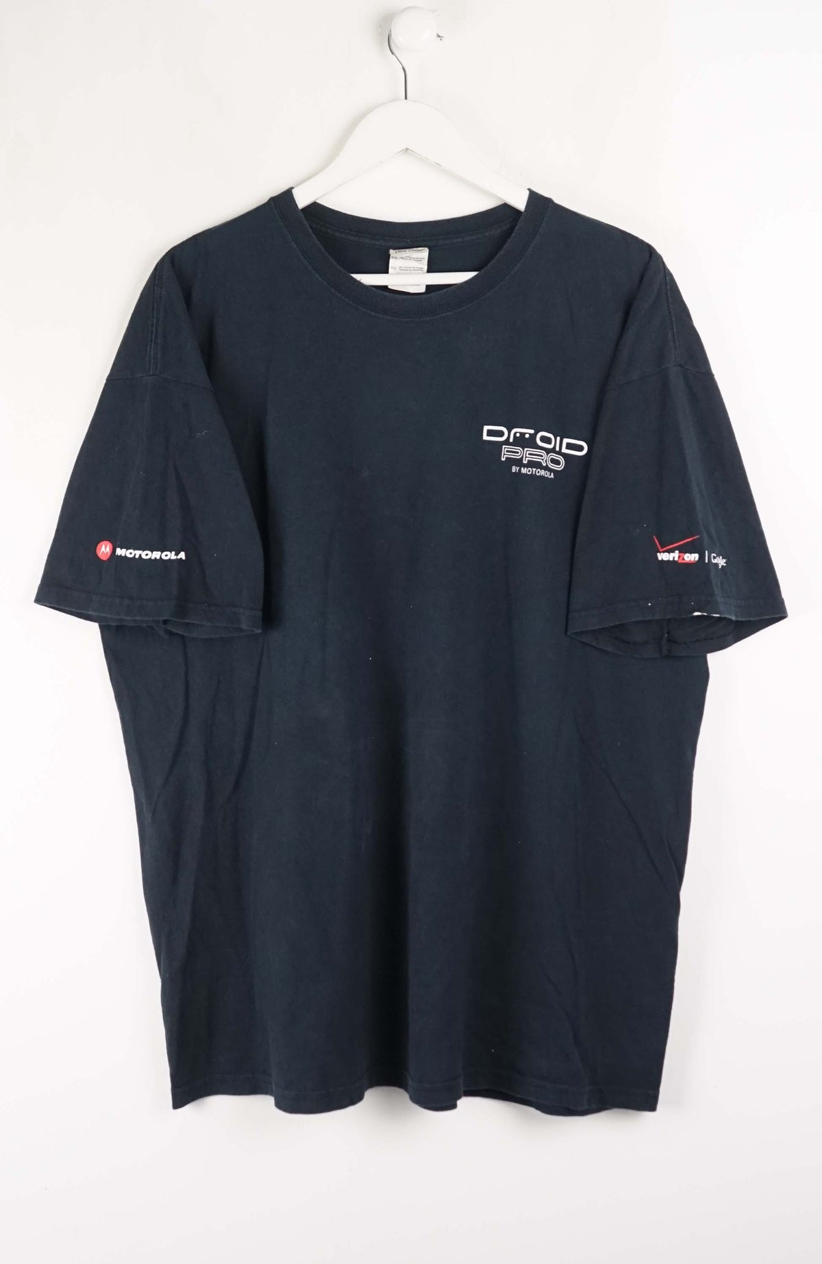 Navy blue t-shirt with logos on a white background