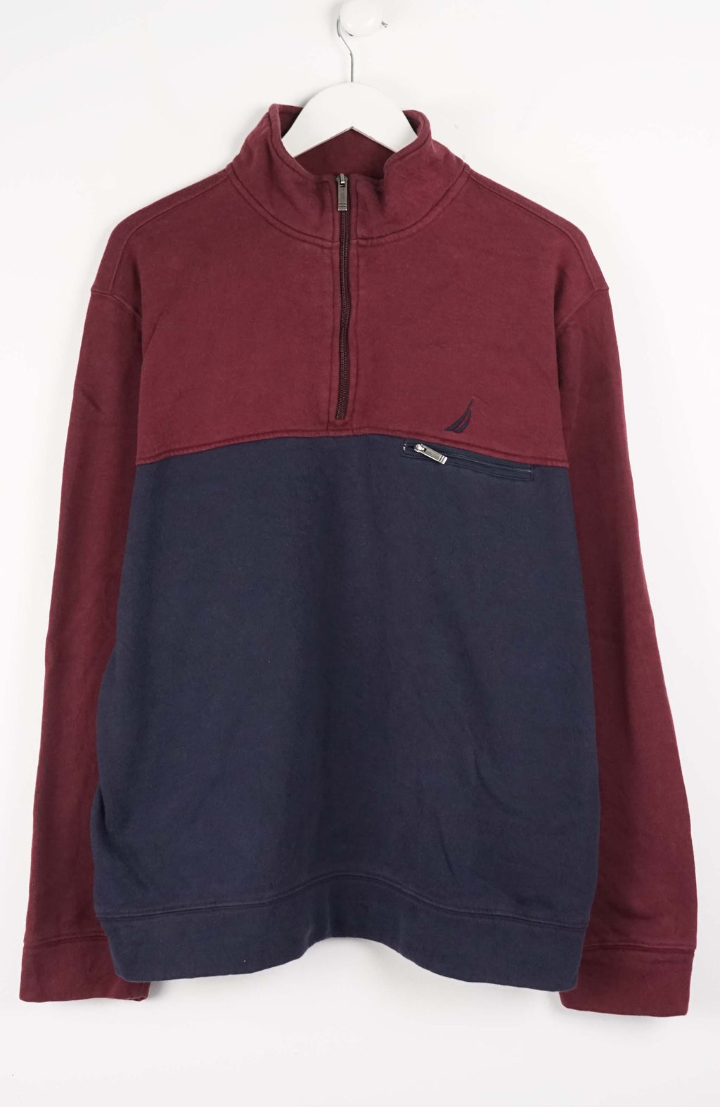 Maroon and navy pullover with a brand logo on a white background