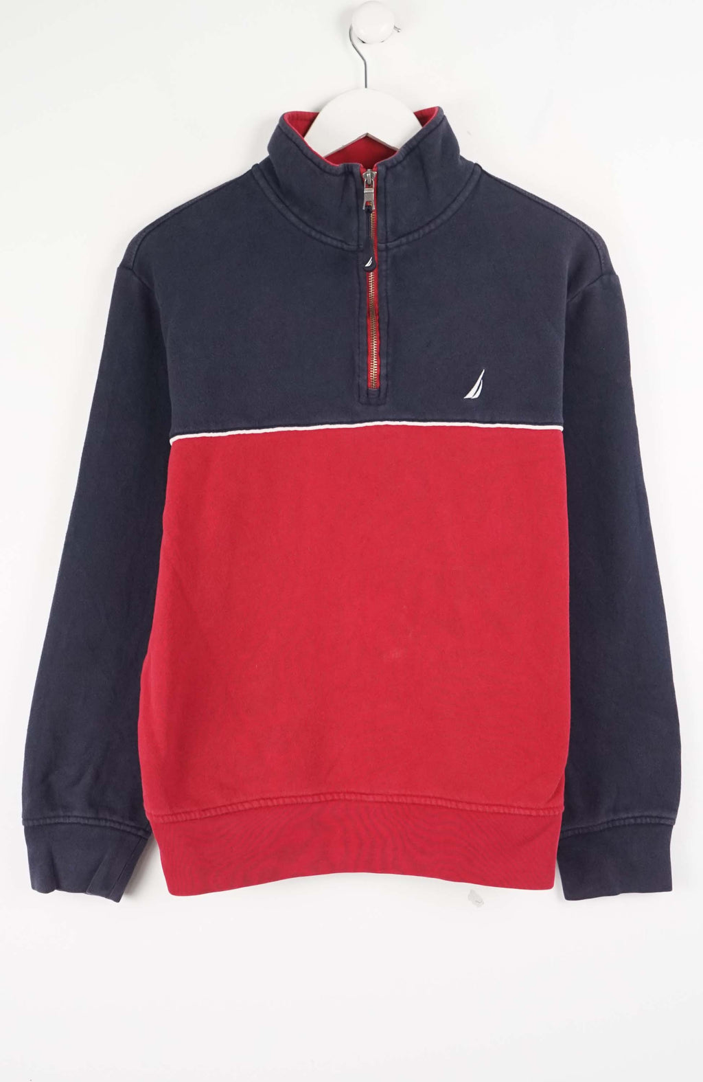 Navy and red pullover with a brand logo on a white background