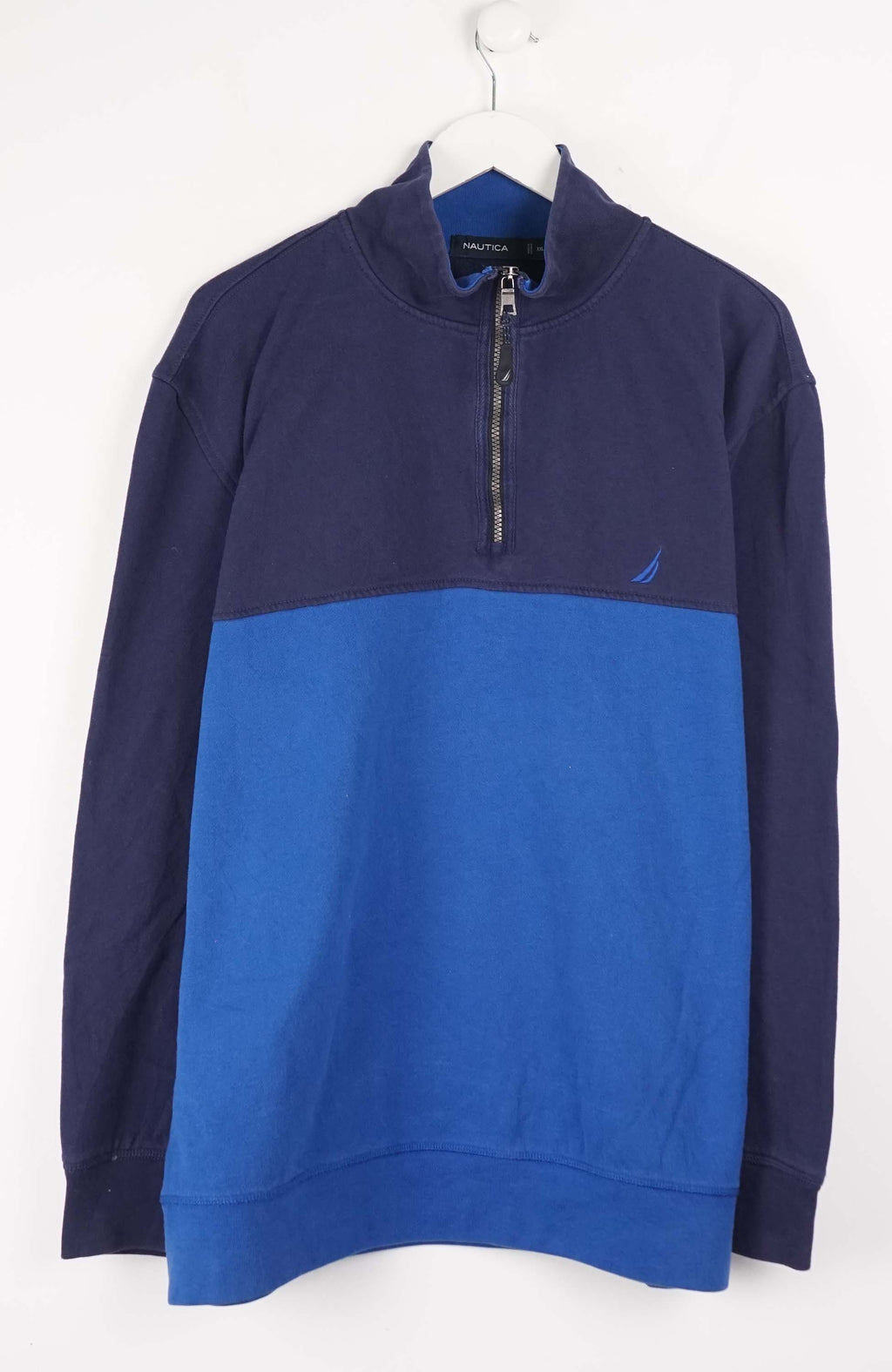 Blue and navy pullover with a brand logo on a white background