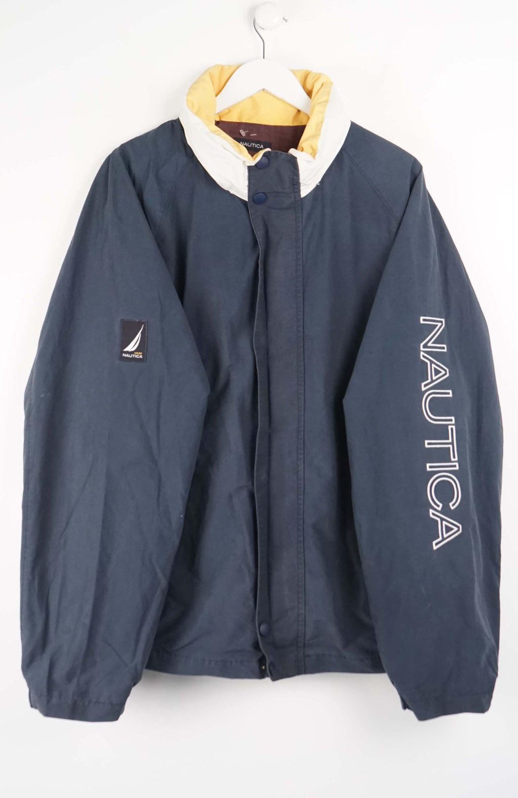 Nautica jacket on a hanger against a white background