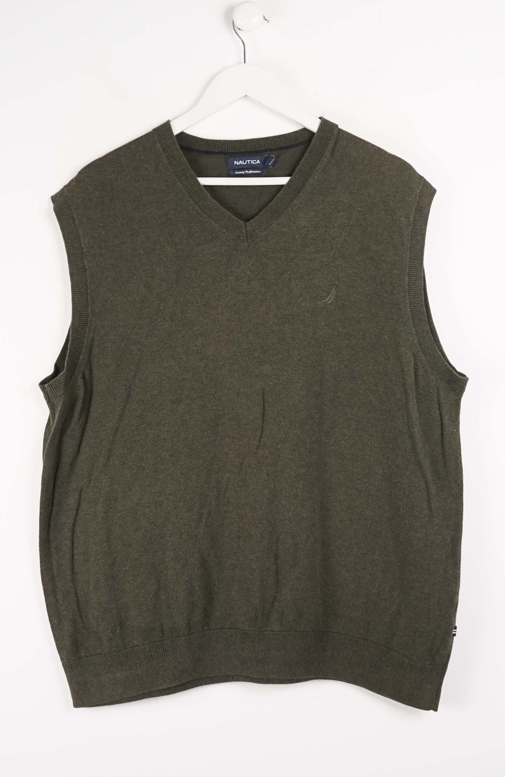 Green sweater vest on a white hanger with a white background