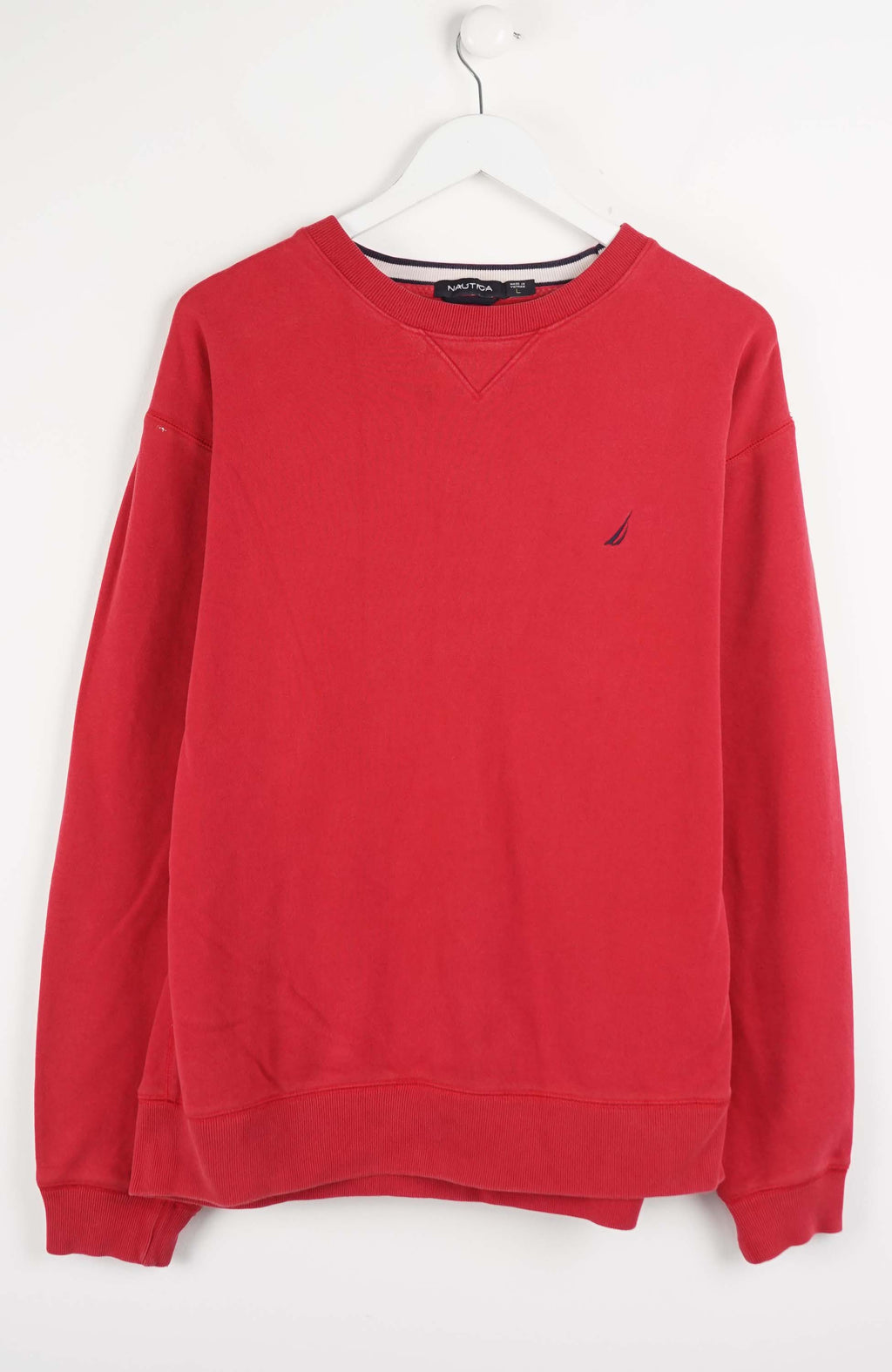 Red sweatshirt with a small logo on a white hanger against a white background