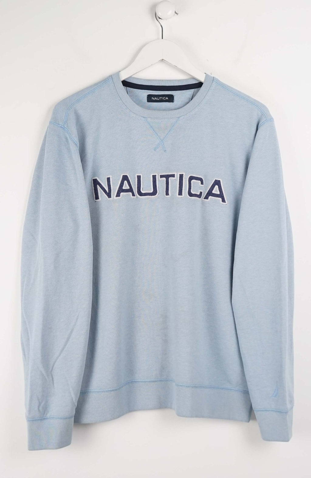 Light blue Nautica sweatshirt on a white hanger against a white background