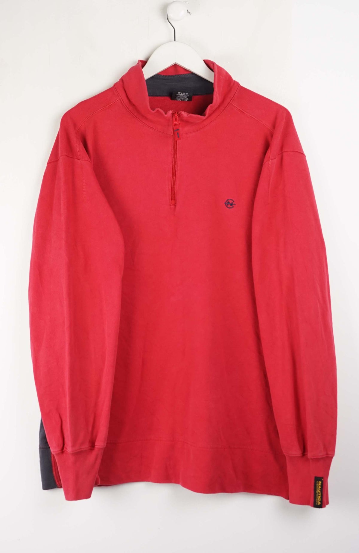 Red long-sleeve shirt on a hanger against a white background