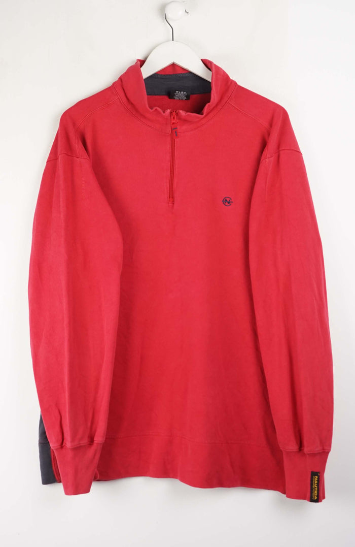 Red long-sleeve shirt on a hanger against a white background
