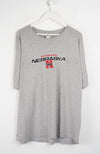 Gray t-shirt with Nebraska logo on a white background
