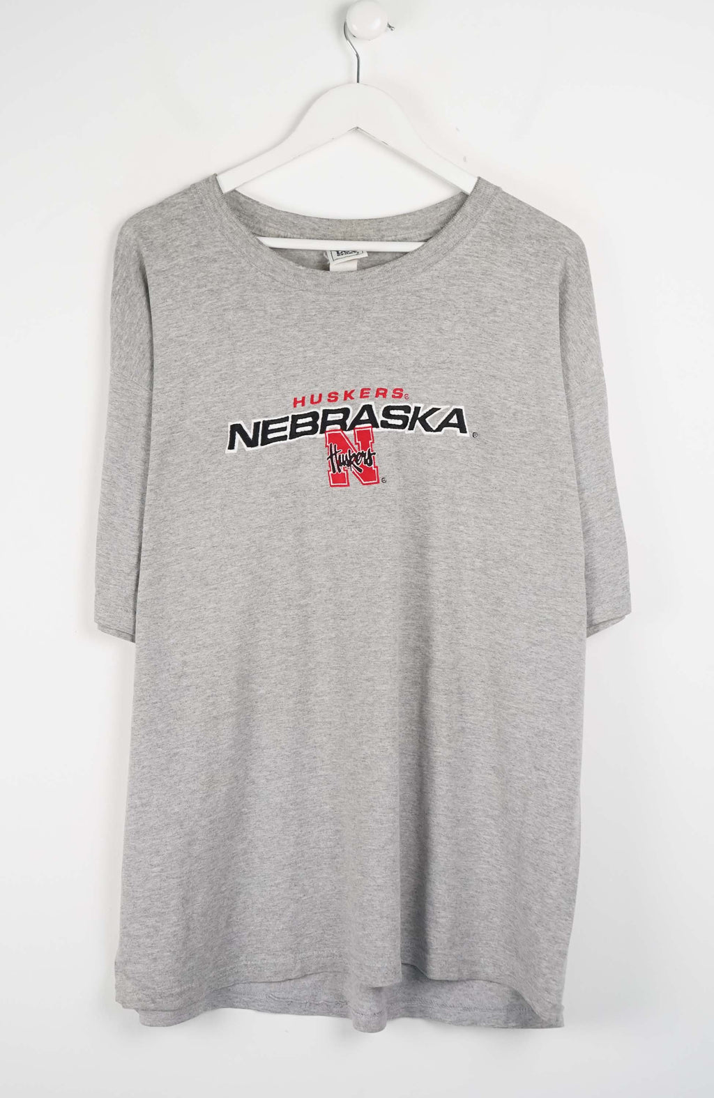 Gray t-shirt with Nebraska logo on a white background