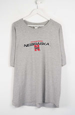 Gray t-shirt with Nebraska logo on a white background