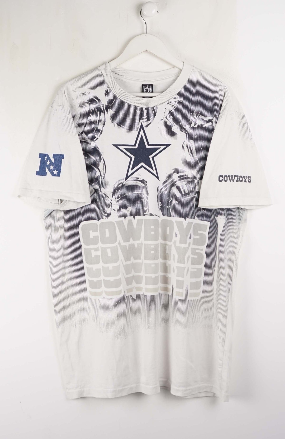T-shirt with Dallas Cowboys logo and text on a white background