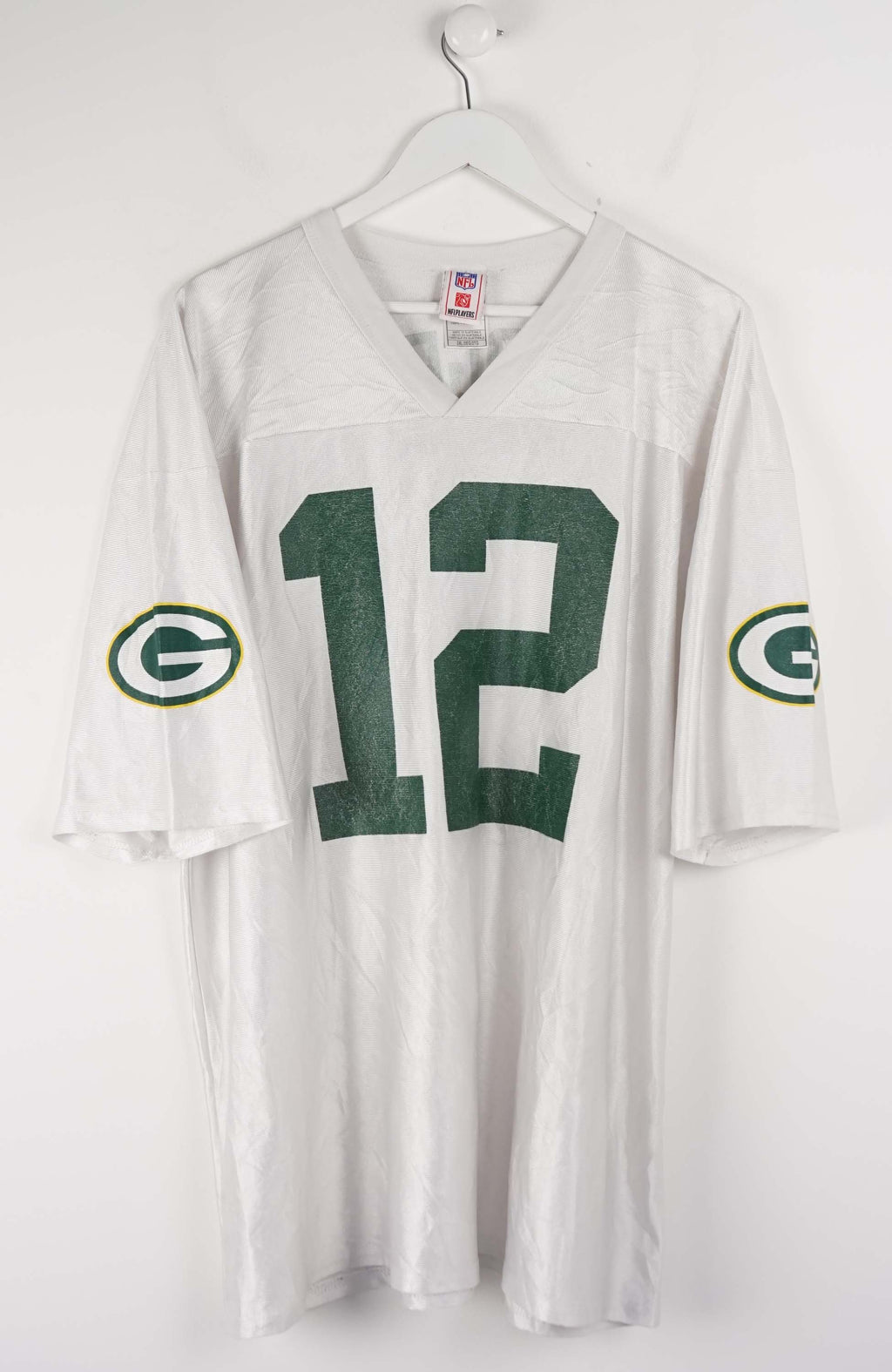 White sports jersey with number 12 and Green Bay Packers logos on a white background